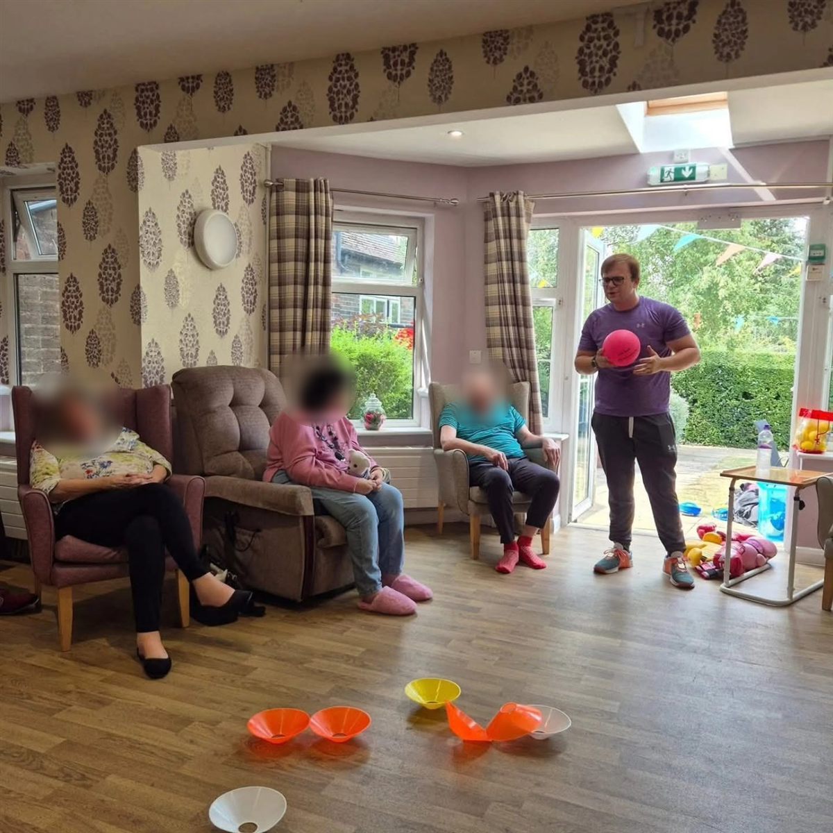 Andrew Hill running a ball exercise session with care home residents